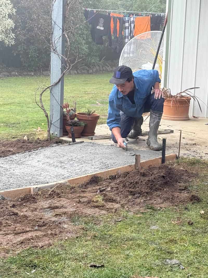 Civil contractor in Tasmania smoothing freshly laid concrete for a residential path